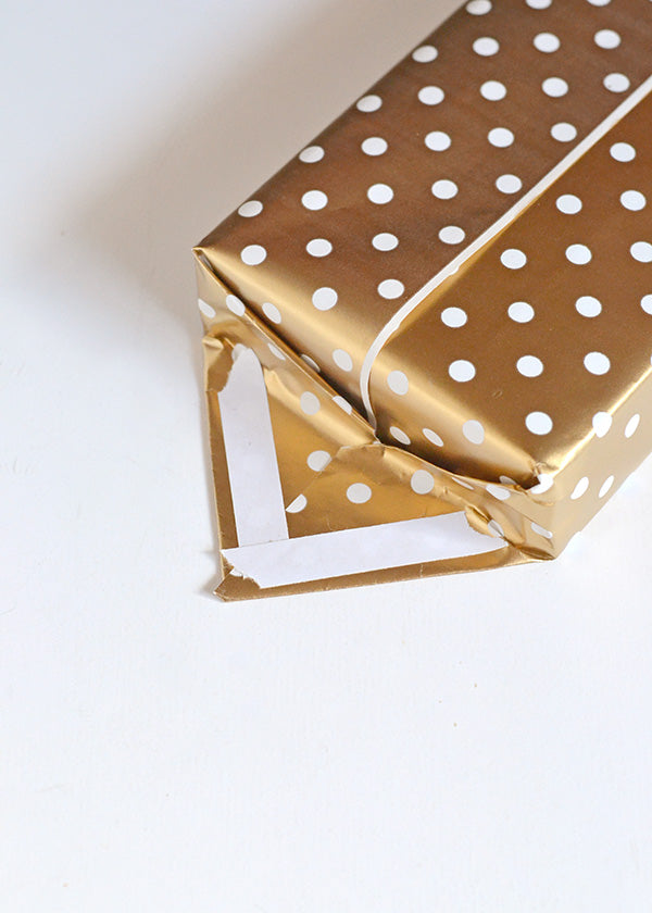 A trick to wrap gifts without tape showing Make and Tell